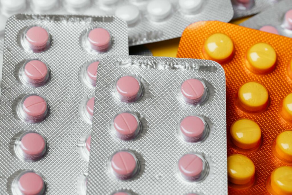 Close-up of multicolored pills in blister packs, showcasing pharmaceutical packaging.